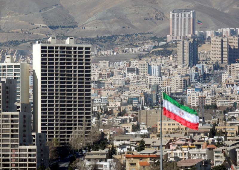 Tehran urban skyline and Iran flag