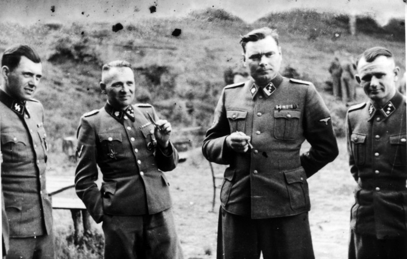 Dr Josef Mengele (1911-1979) left, known as 'The Angel of Death' for the medical experiments he carried out on the inmates of Auschwitz, the German Nazi concentration. Next to him is Rudolf Höss, Commandant of Auschwitz; Second from right is Josef Kramer,